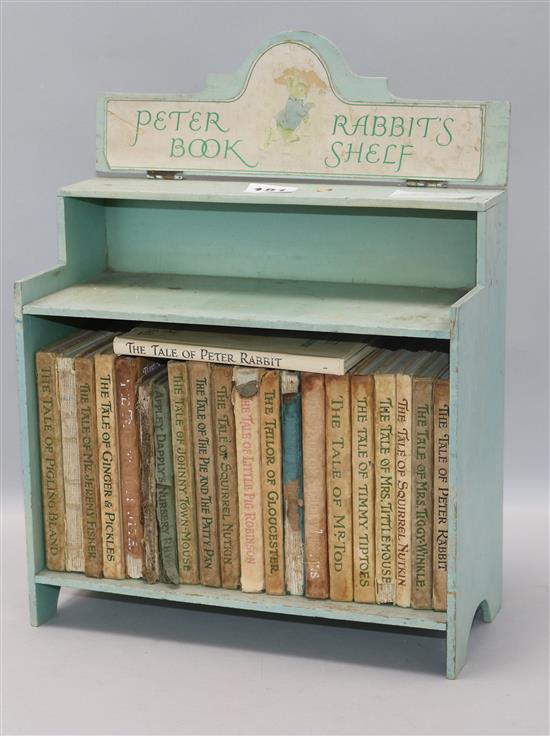 A collection of Beatrix Potter books in cabinet